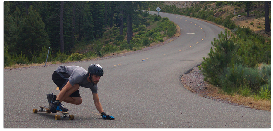 longboarding down mountain hill road