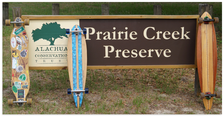 longboards posing with prairie creek preserve sign