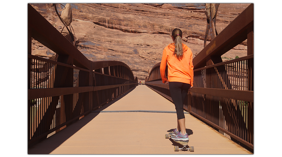 crossing the bridge while longboarding moab canyon trail