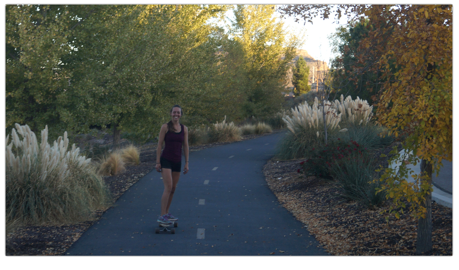 longboarding cruising on a scenic paved path