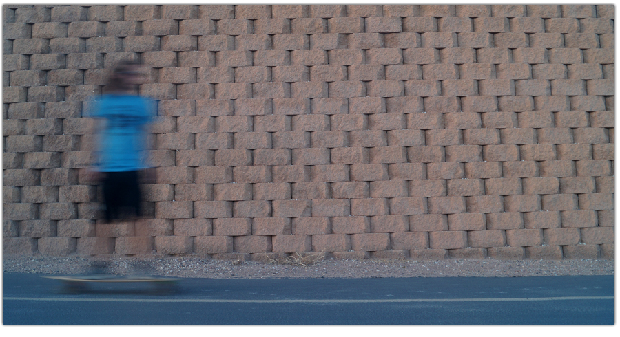 blurry longboarder