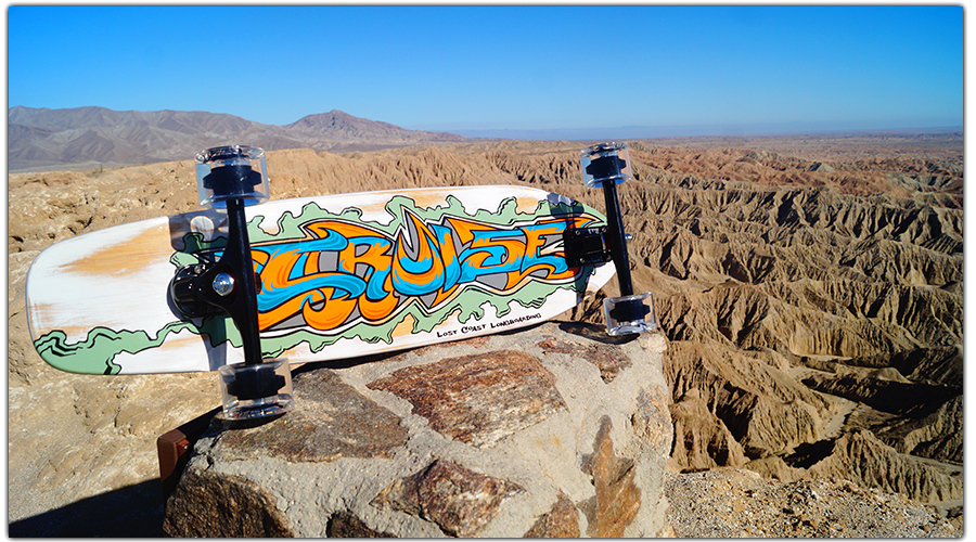 lost coast longboarding handpainted longboard in front of fonts point badlands overlook