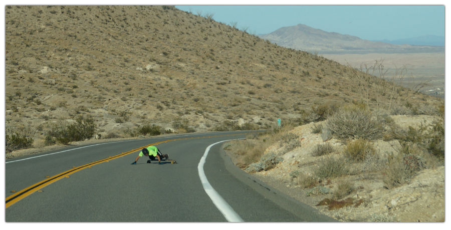 longboarder slowing down by sliding on yaqui pass run
