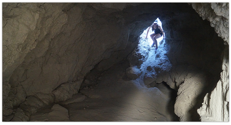 hiker entering mud cave