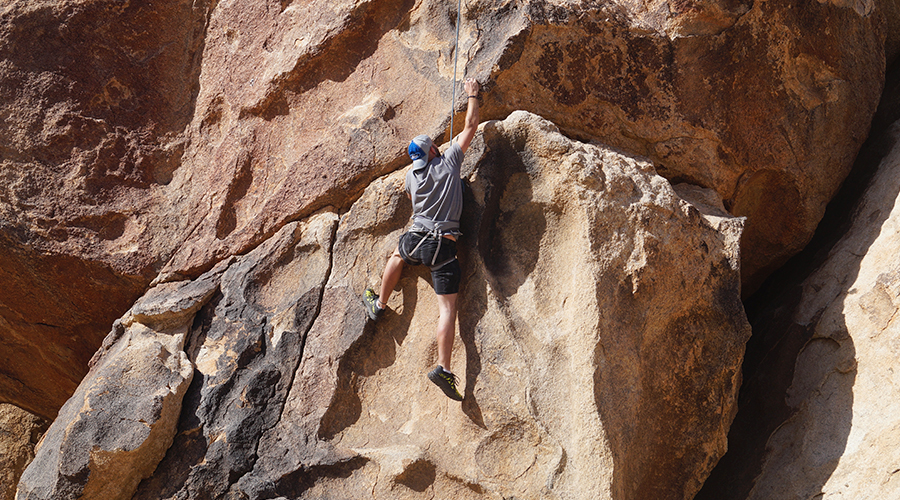 rock climbing with ropes and harness in joshua tree