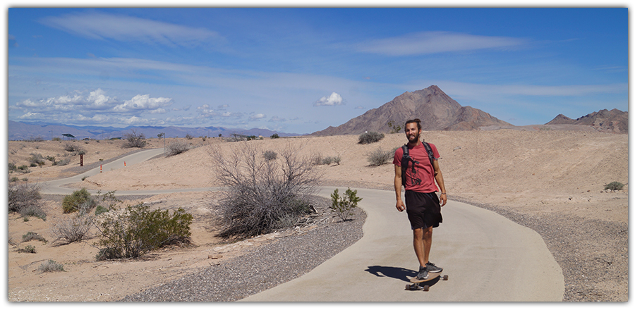 longboarding cruising on a paved path in las vegas