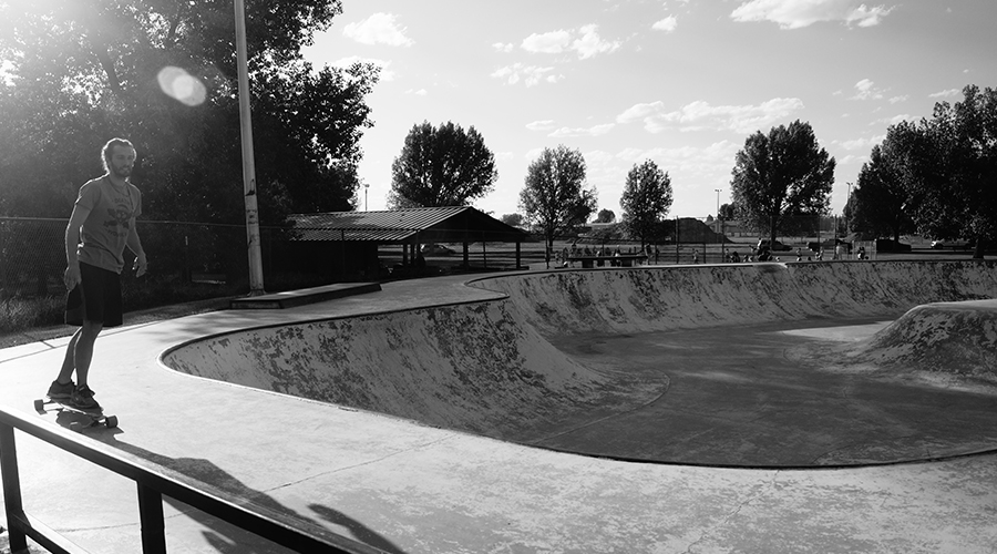 Lost Coast Longboarding skating around big bowl at Laramie Skatepark