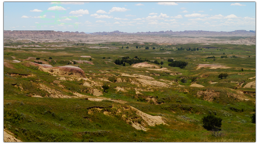 mix of prairie and badlands sprawling below scenic drive