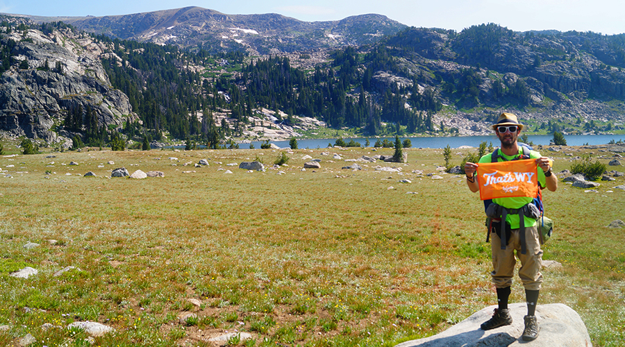 hiker with that's wyoming sign