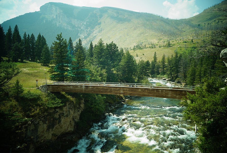 wooden bridge over boulder river