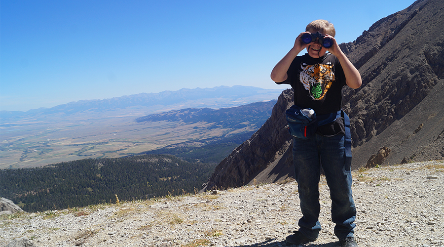 kid using binoculars atop sacagawea peak