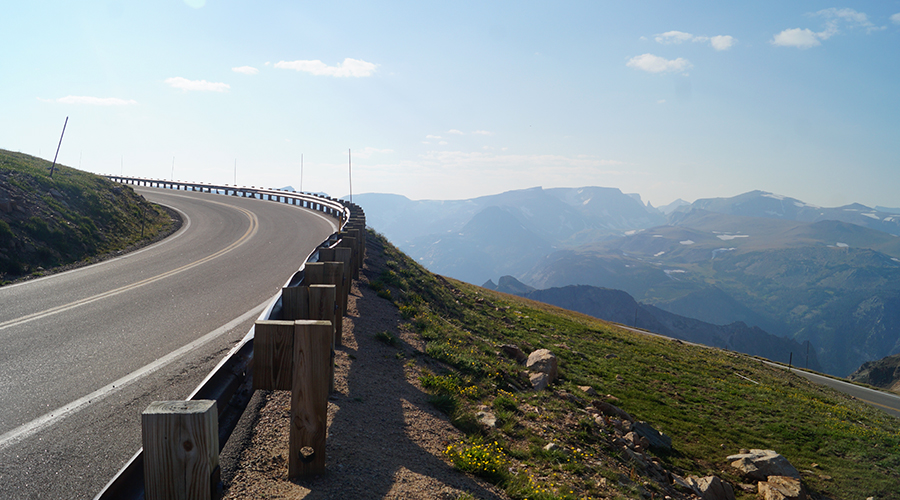 guardrails and mountain tops while longboarding beartooth highway