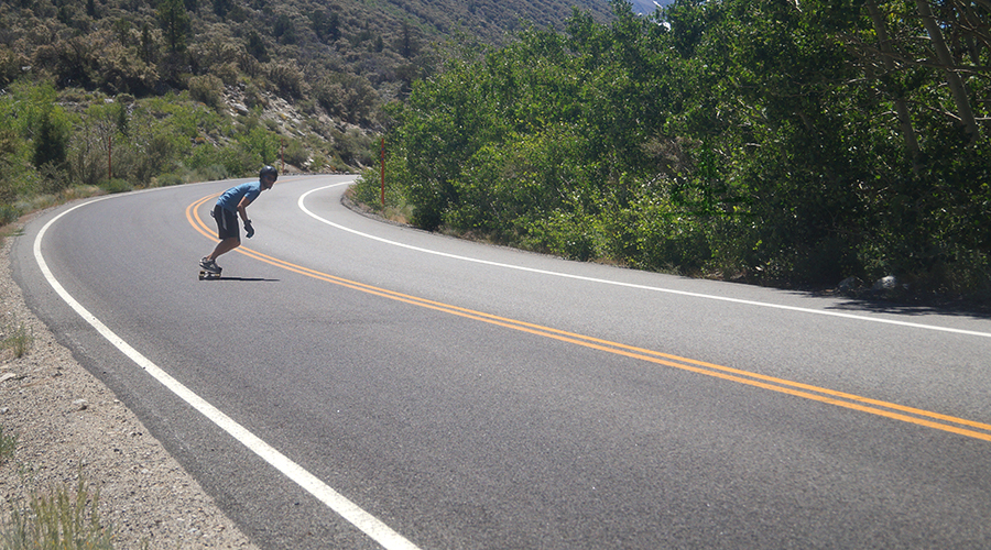 cruising along rock creek road on a longboard