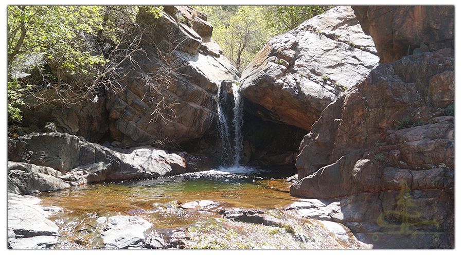 small waterfall pouring over the boulders