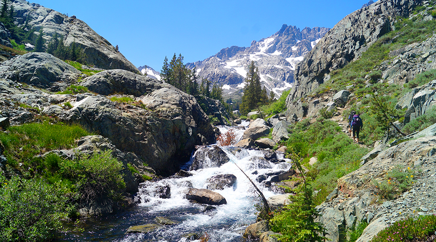 rugged trail paralleling the rushing river