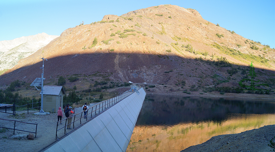 crossing the dam to start hiking along the lakeshore