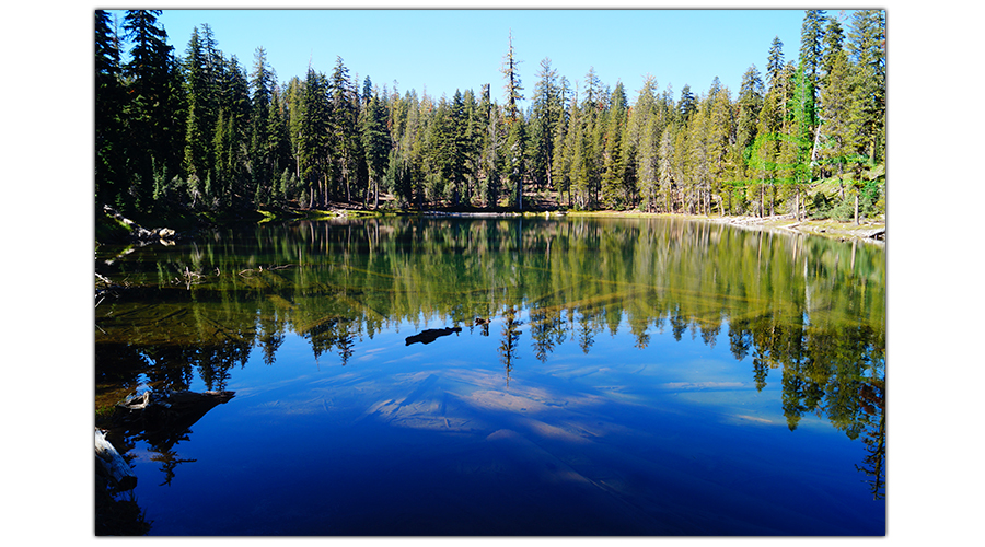 another beautiful forested lake while backpacking lassen volcanic national park