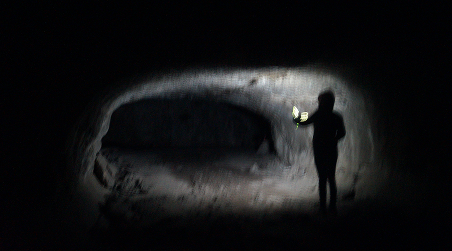 walking through the darkness of the lava tube