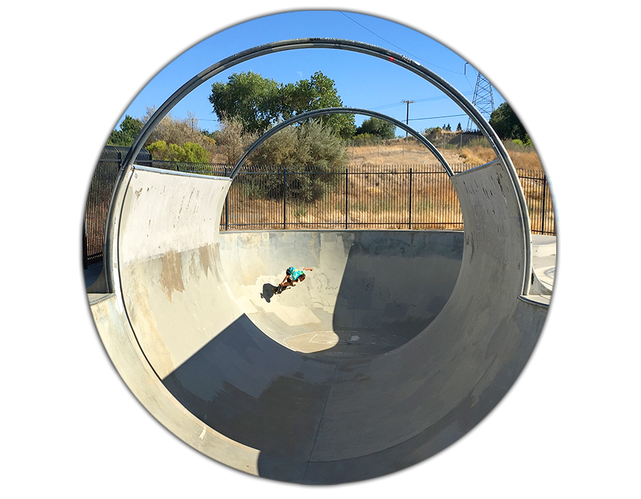 cruising through the tunnel in the large bowl at the granite skatepark in sacramento california