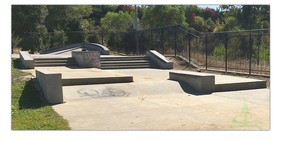 street section of granite skatepark with stairs, boxes and ledges