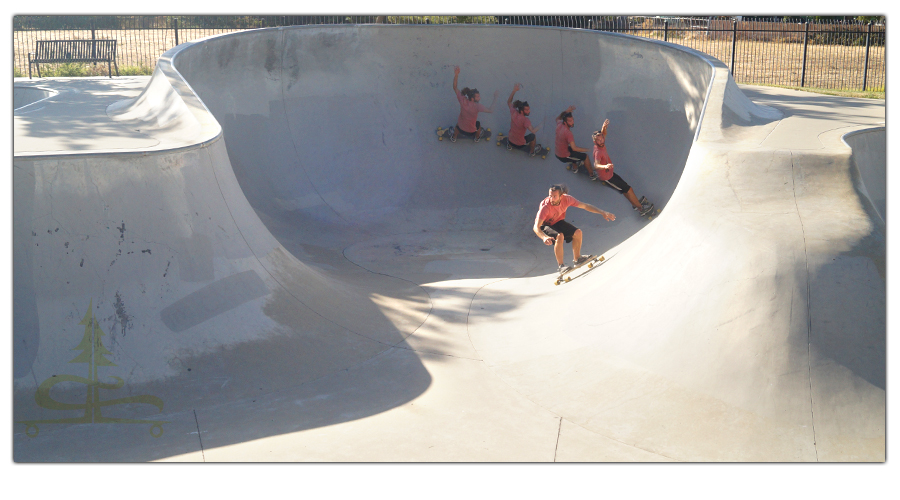 shredding the large bowl on a longboard