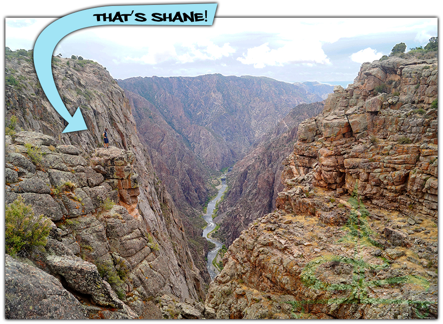 steep canyon view with the river flowing down below