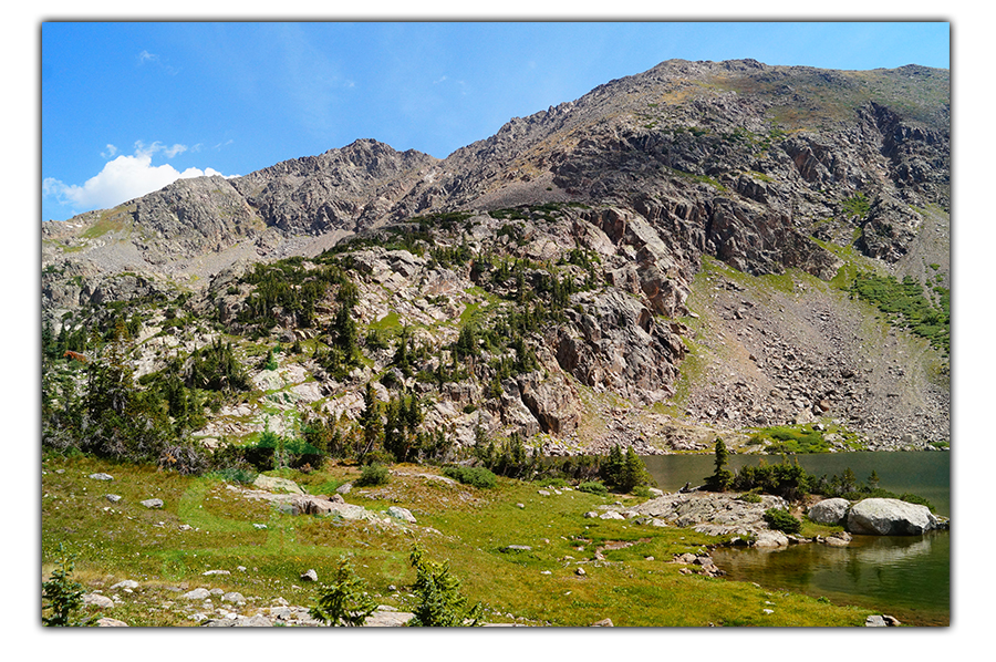 steep rugged mountain backdrop at missouri lake