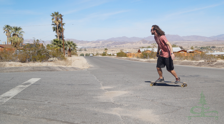 taking a turn while longboarding in twentynine palms