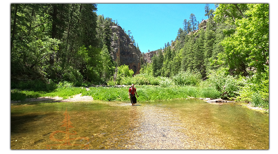 wading through the water to cool off while hiking point trail