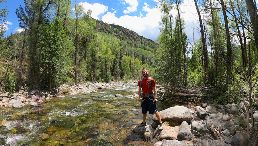 Shane standing by cascade creek