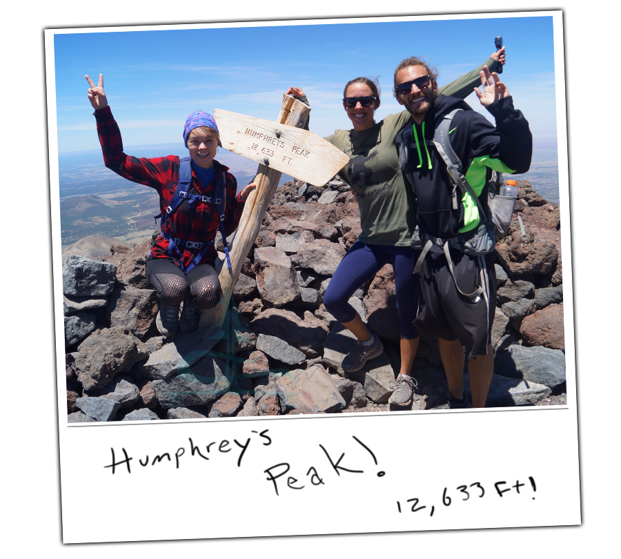 posing with the humphreys peak sign at the summit