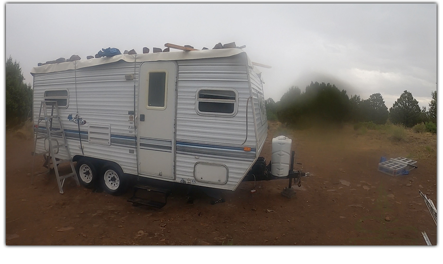 working on our travel trailer roof while camping near montrose