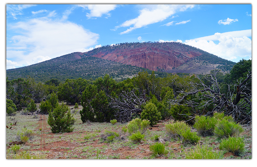 distant view of red mountain area from the road