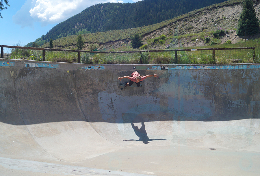 getting high in the bowl on a longboard at the crested butte skatepark
