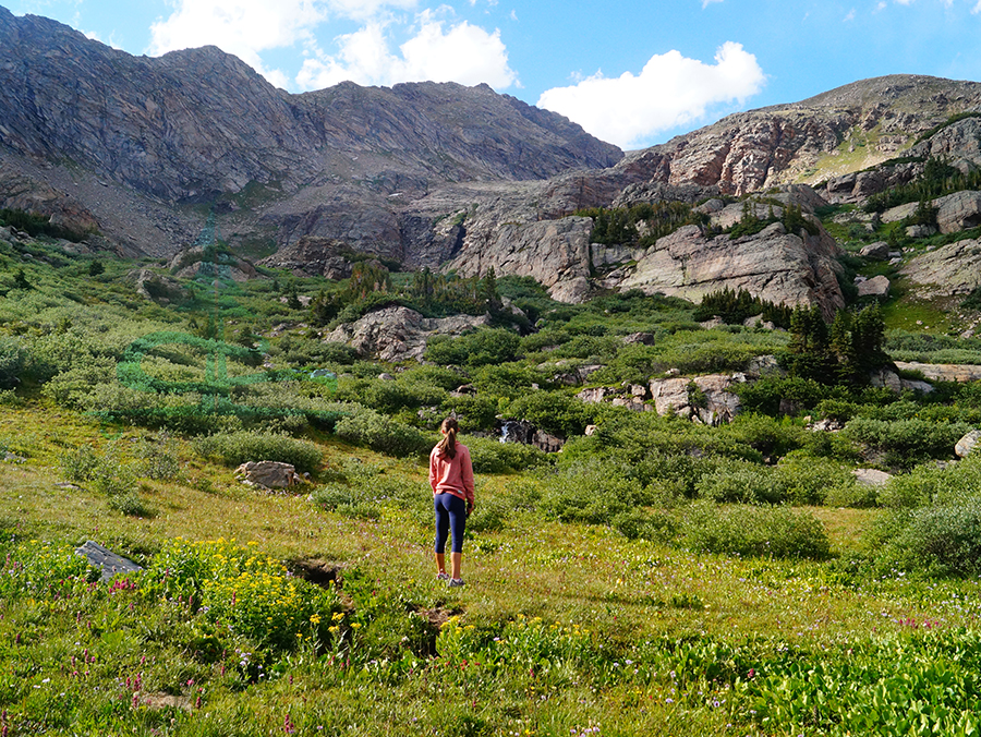 enjoying the view of the waterfall, greenery and towering mountains