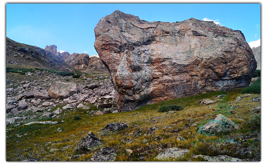 huge boulder on resting on the rocky hillside