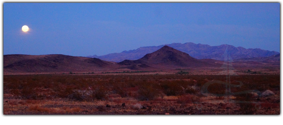 full moon over the vast desert scenery