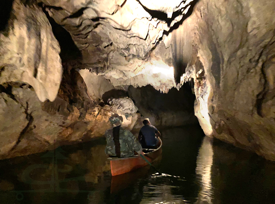 exploring barton creek cave on a canoe