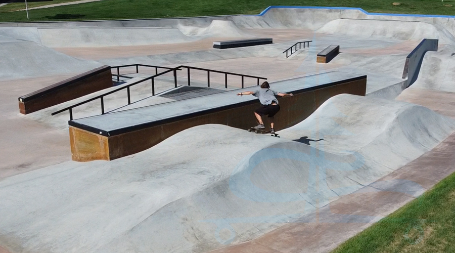 longboarding the pump track feature at the skatepark in thornton
